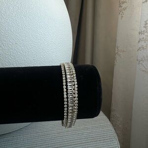 Multi layered tennis bracelet with baguette center row